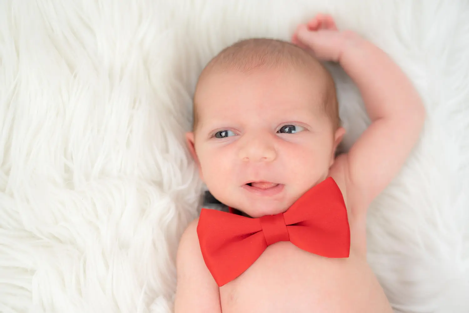 Melissa Herkommer Fotografie, Neugeborene, Baby mit roter Schleife